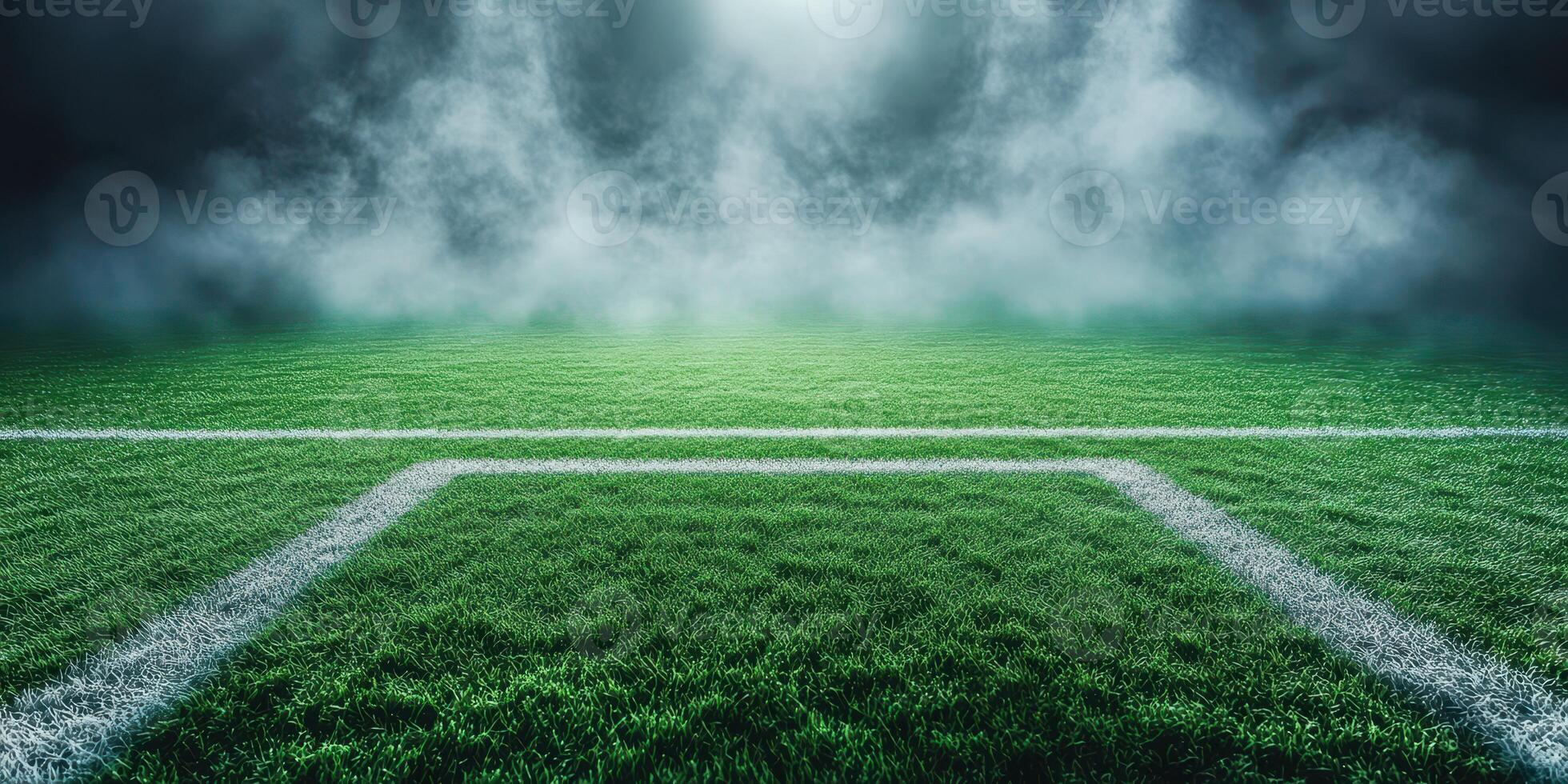 Empty soccer field under dramatic lighting and fog during dusk in a quiet stadium photo