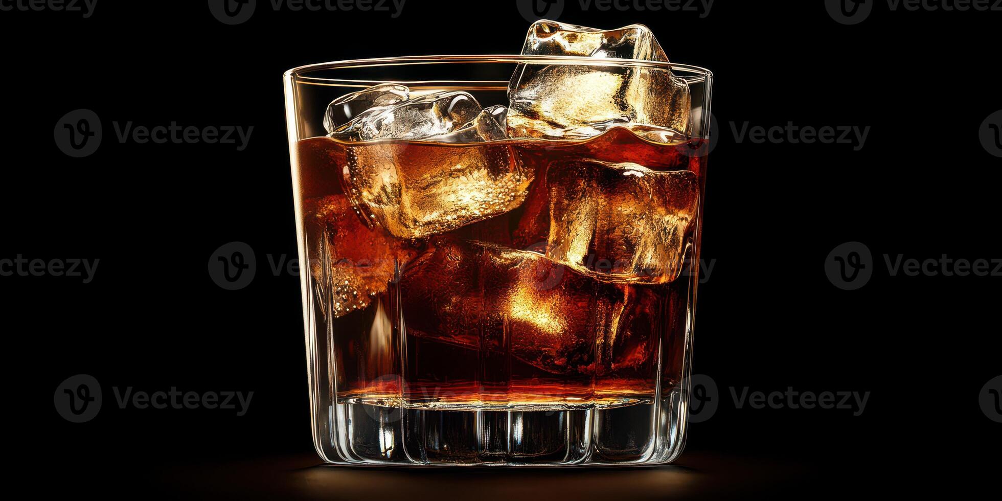 Refreshing glass of dark beverage with ice cubes against a black background photo