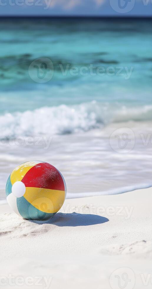 colorful beach ball rests on white sandy shore, surrounded by gentle waves and serene ocean backdrop photo