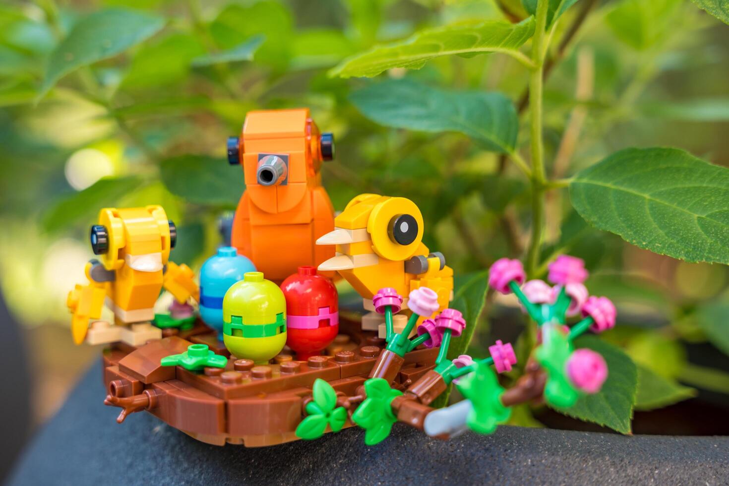 Osnice, Czech republic - July 28, 2024. Close-up of a Lego picnic scene with colorful toy birds photo