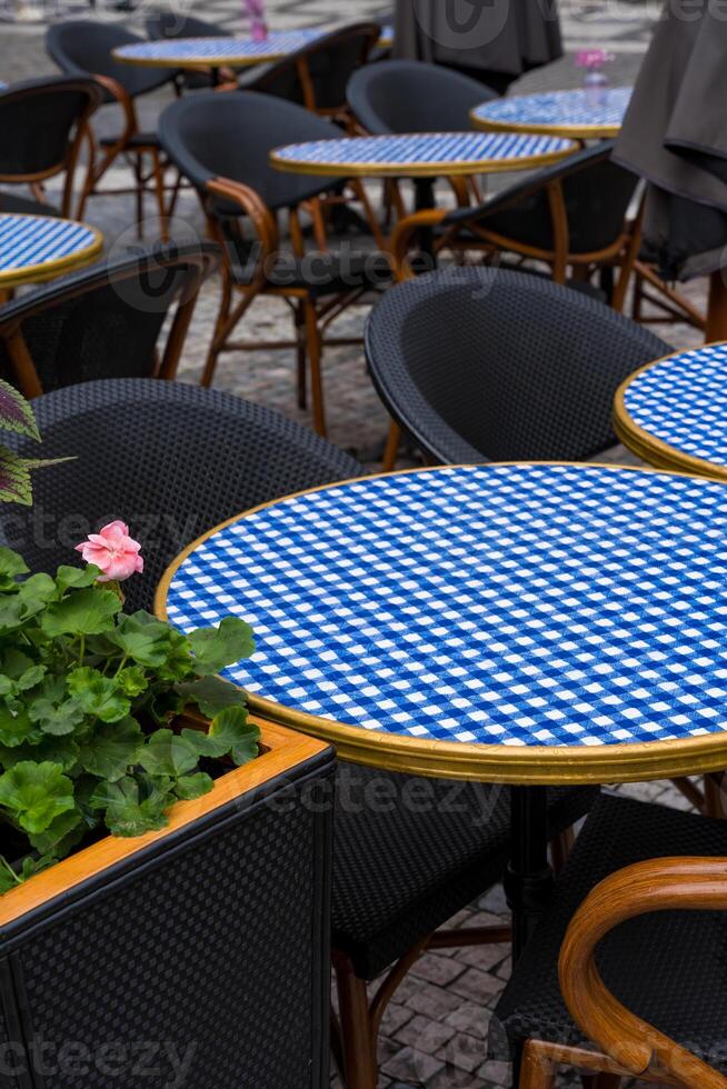 Outdoor cafe blue checkered tables with blue checkered tablecloths in Prague photo