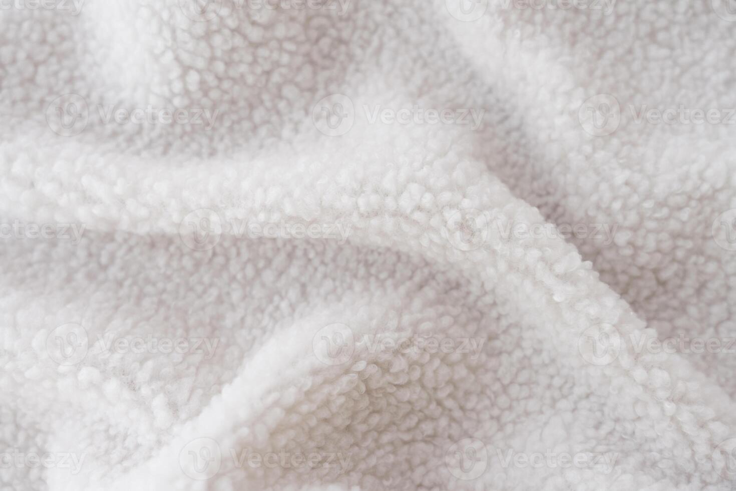 Macro shot of sustainable sherpa fleece textile in white color. photo