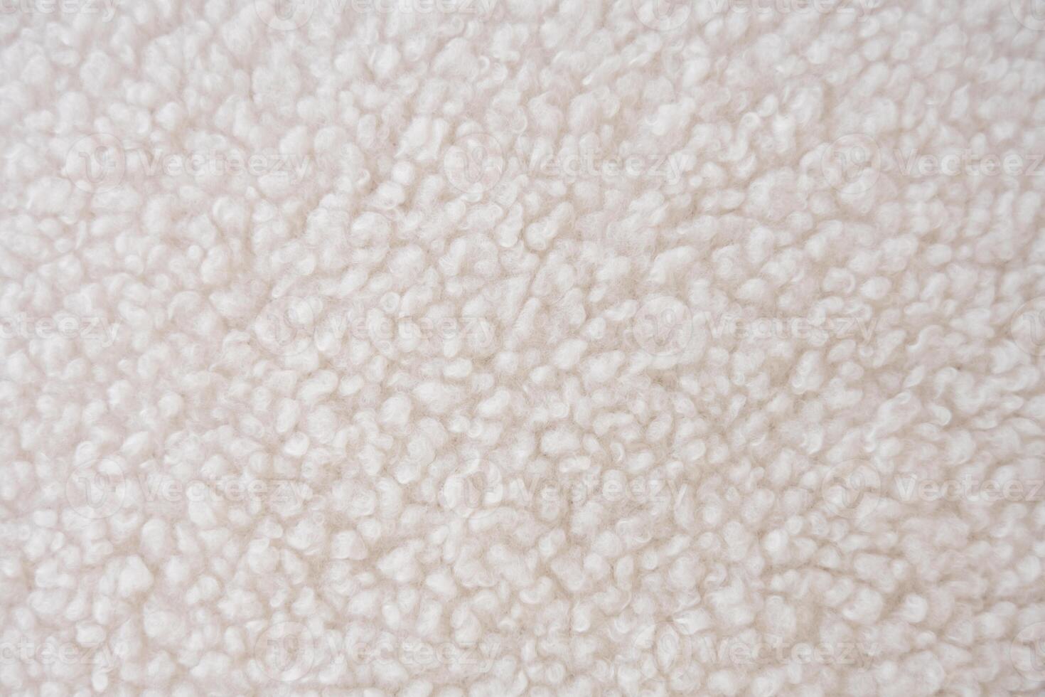 Detailed close-up of plush white sherpa fleece fabric with a wavy, curly pattern photo