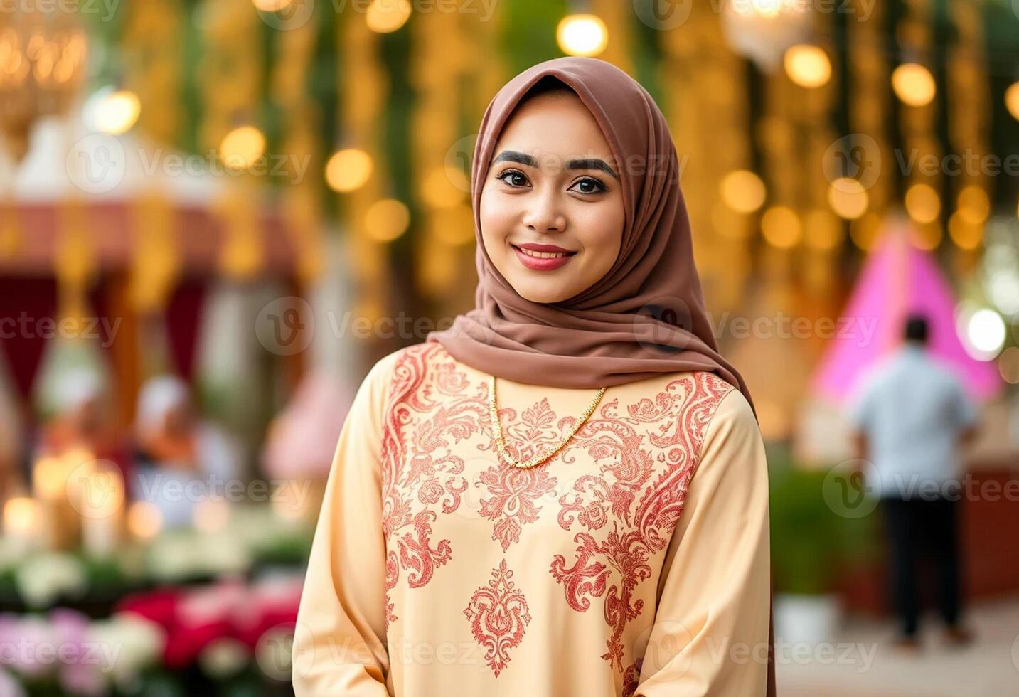 A woman wearing a hijab is standing in front of a crowd photo