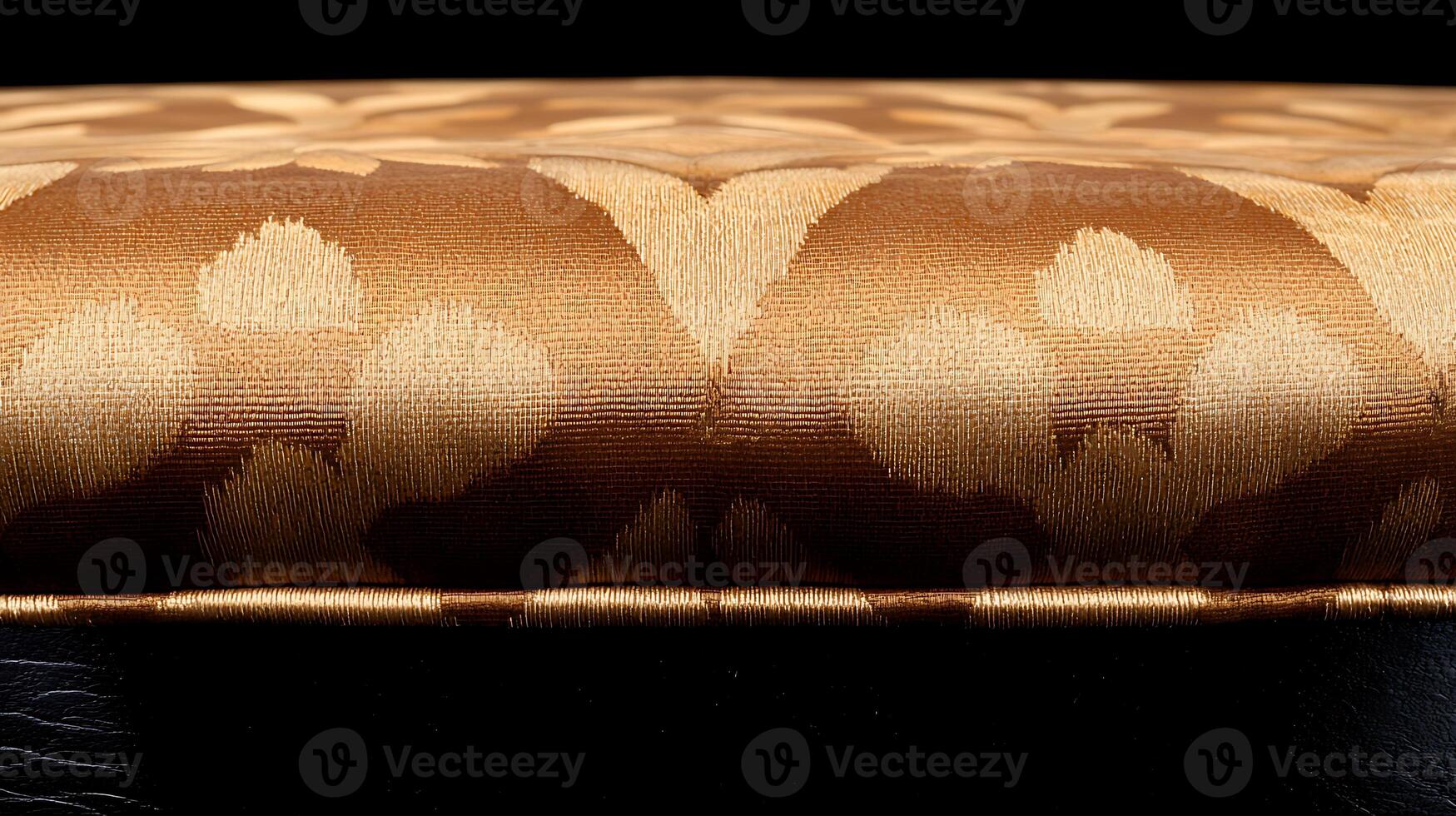Close-up view of an elegant upholstered cushion showcasing intricate golden patterns against a dark background photo