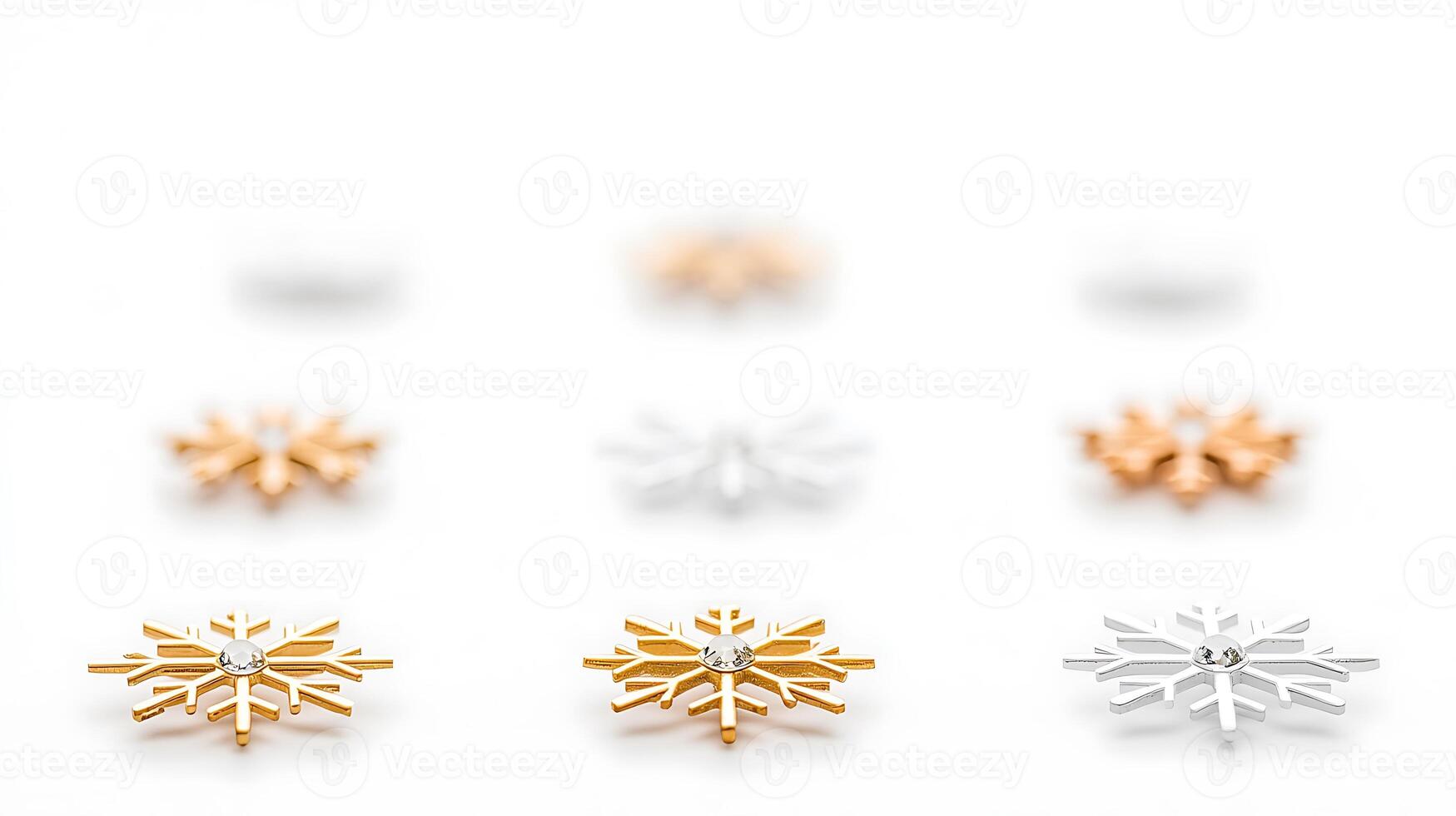 Close-up view of decorative snowflake ornaments in gold and silver on a white background photo
