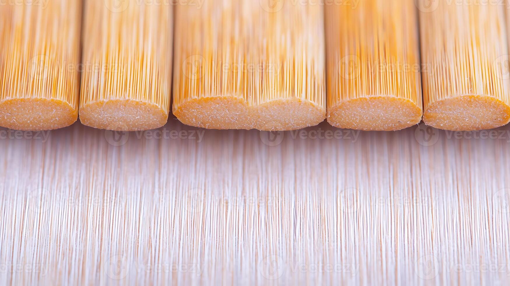 Close-up view of cut bamboo sticks arranged neatly on a smooth surface, showcasing texture photo
