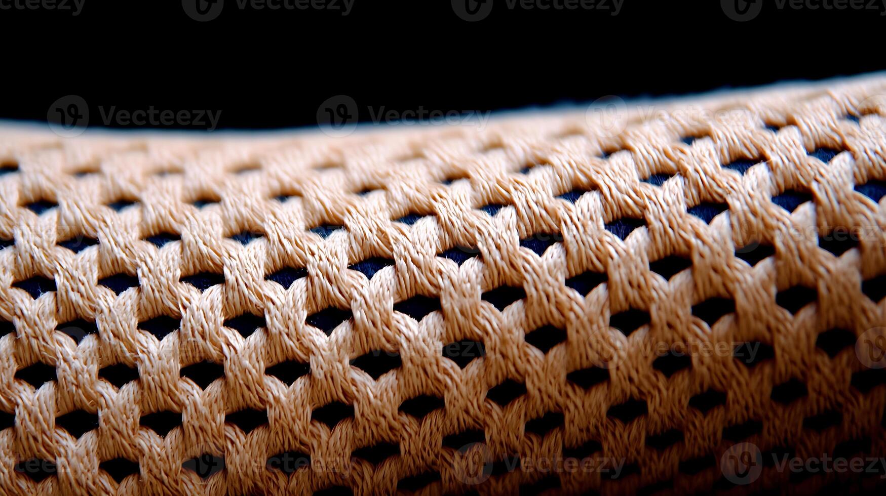 Close-up view of intricately woven fabric showcasing texture and pattern in a dark setting photo