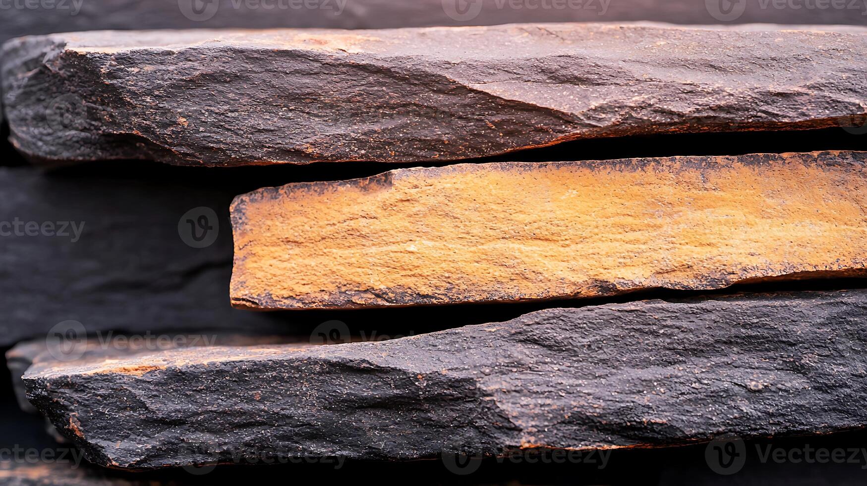 Close-up view of layered dark and orange stones creating a textured surface, ideal for backgrounds photo