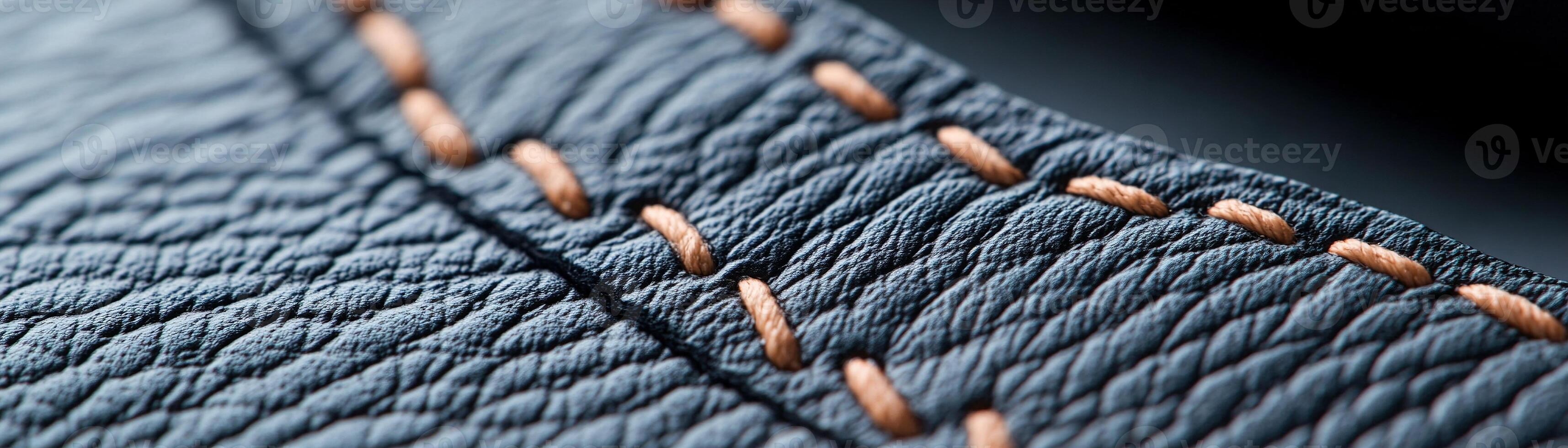 Soft-focus black leather showcases intricate raised stitching in a subtle pattern, creating a stylish and elegant backdrop ideal for branding and promotional text photo