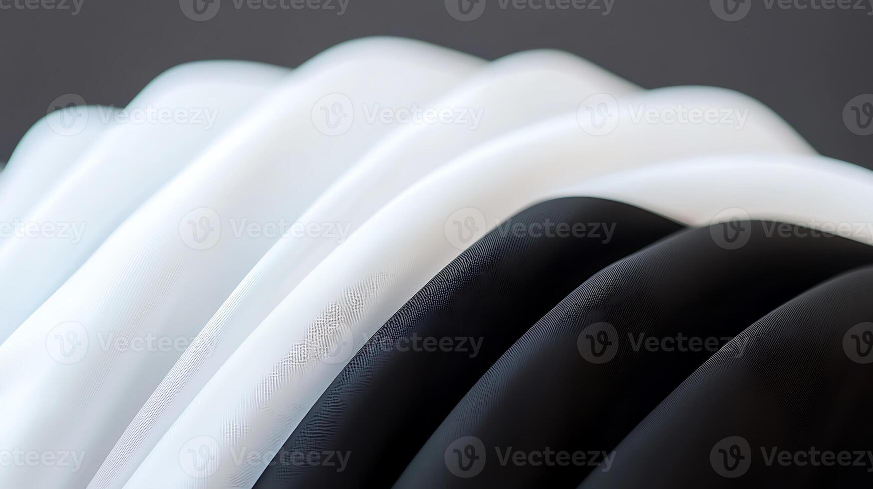 Close-up view of neatly folded black and white fabric showcasing texture and contrast photo