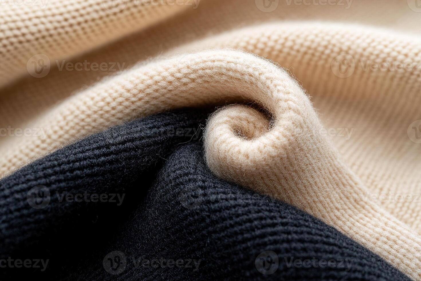 The image features a soft-focus beige wool surface gently blending into a deep black fabric, illustrating an elegant gradient. This textile showcases a contemporary fashion vibe photo