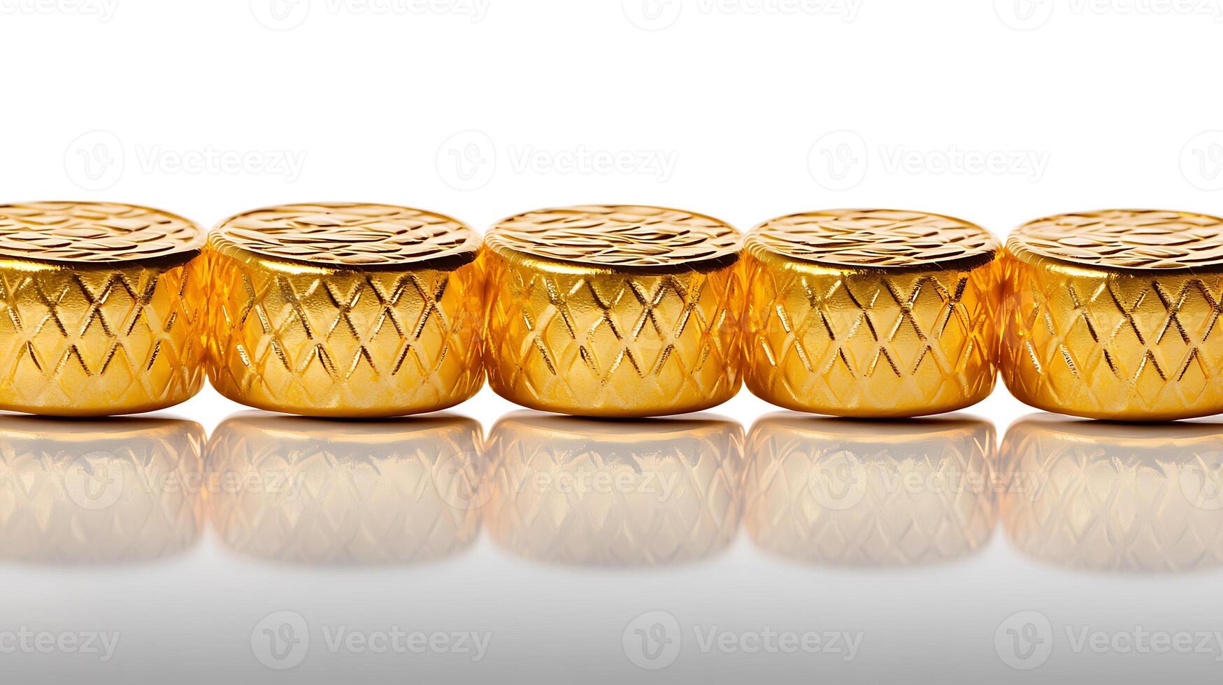Close-up view of shiny gold decorative elements arranged in a line on a reflective surface photo