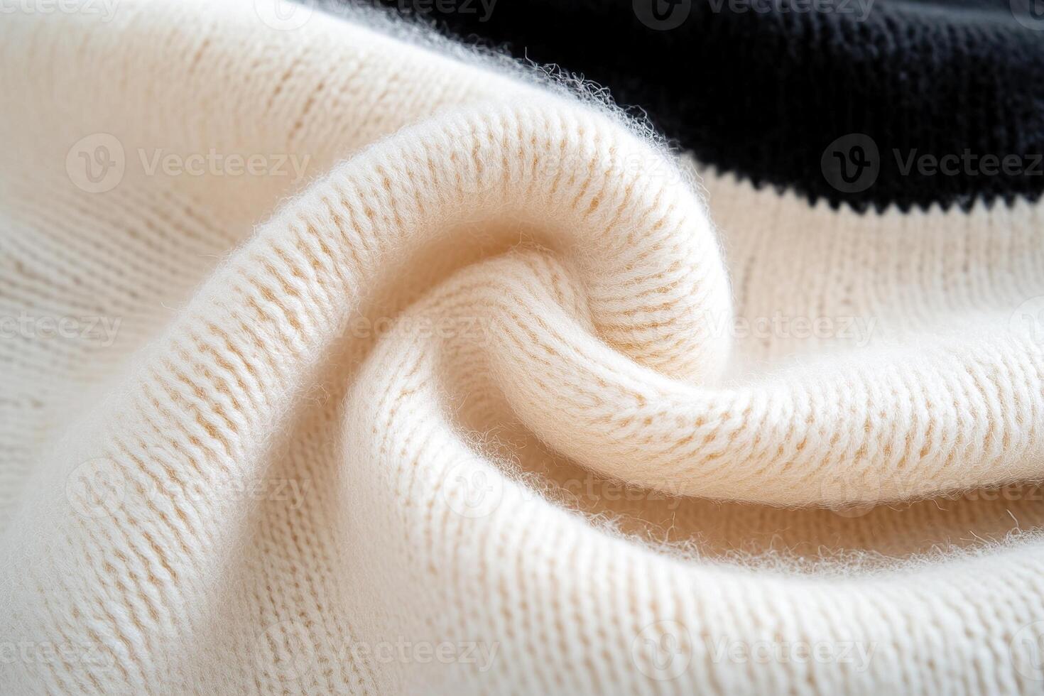 Soft beige wool gradually transitions into deep black, creating a luxe gradient effect that highlights modern fashion. The fabric's texture is inviting and visually appealing photo