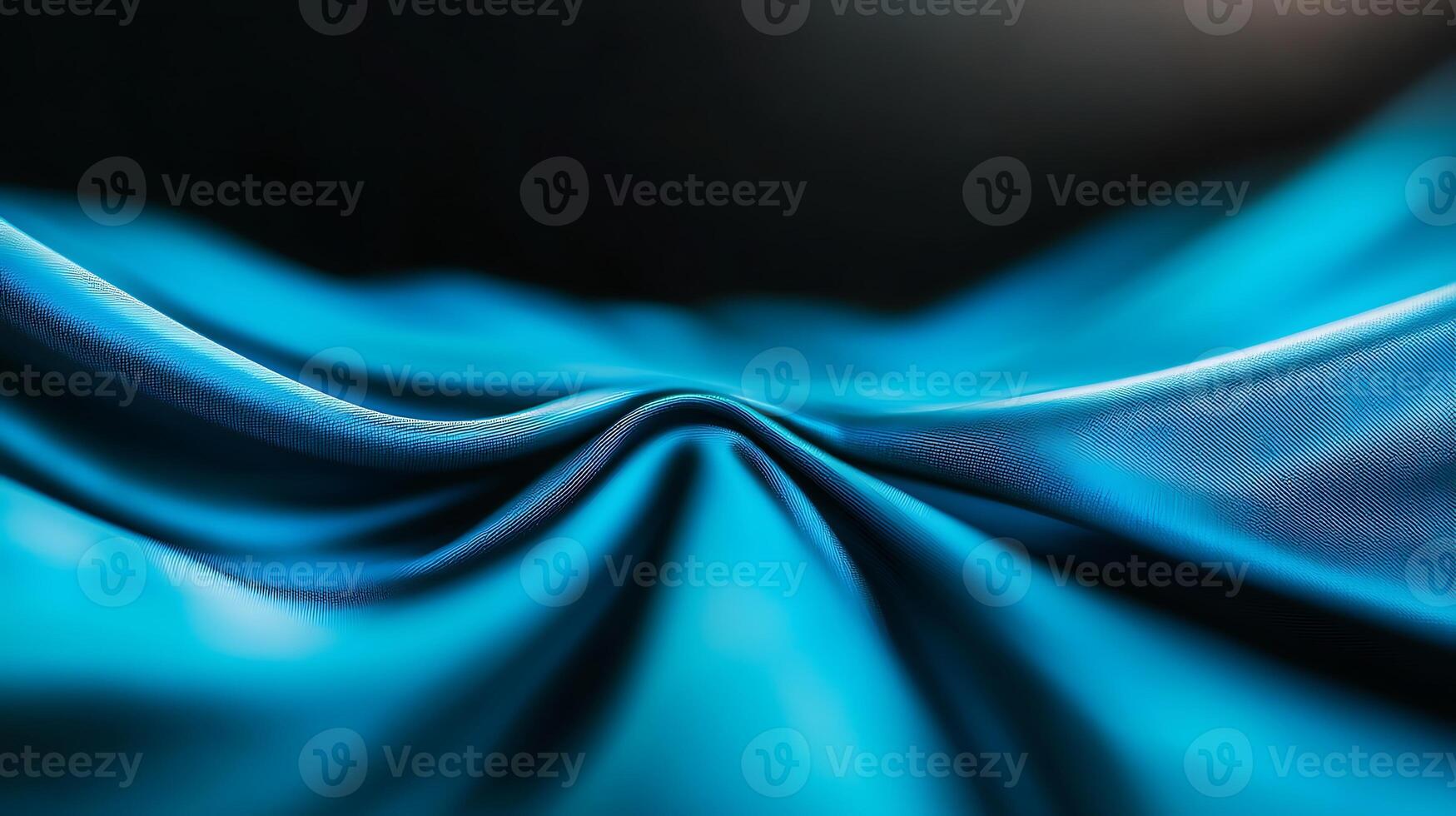 Close-up view of smooth, flowing turquoise fabric with soft folds and shadows in the background photo