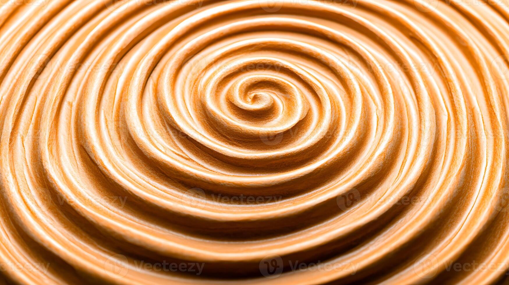 Close-up view of smooth, swirled creamy texture resembling peanut butter on a surface photo