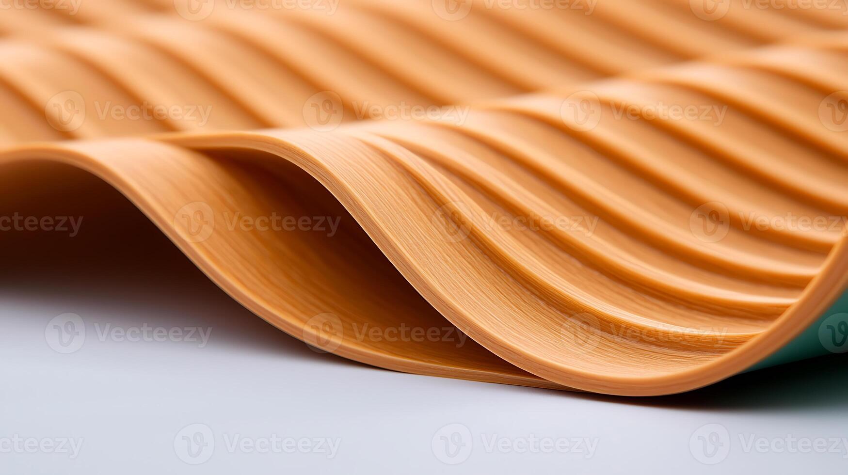 Close-up view of textured orange material with wavy patterns, showcasing its smooth surface and flexibility photo