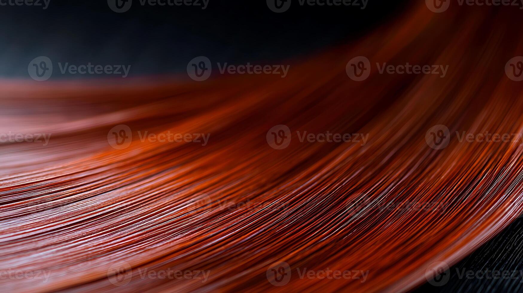 Close-up view of vibrant red hair strands flowing gracefully against a dark background photo