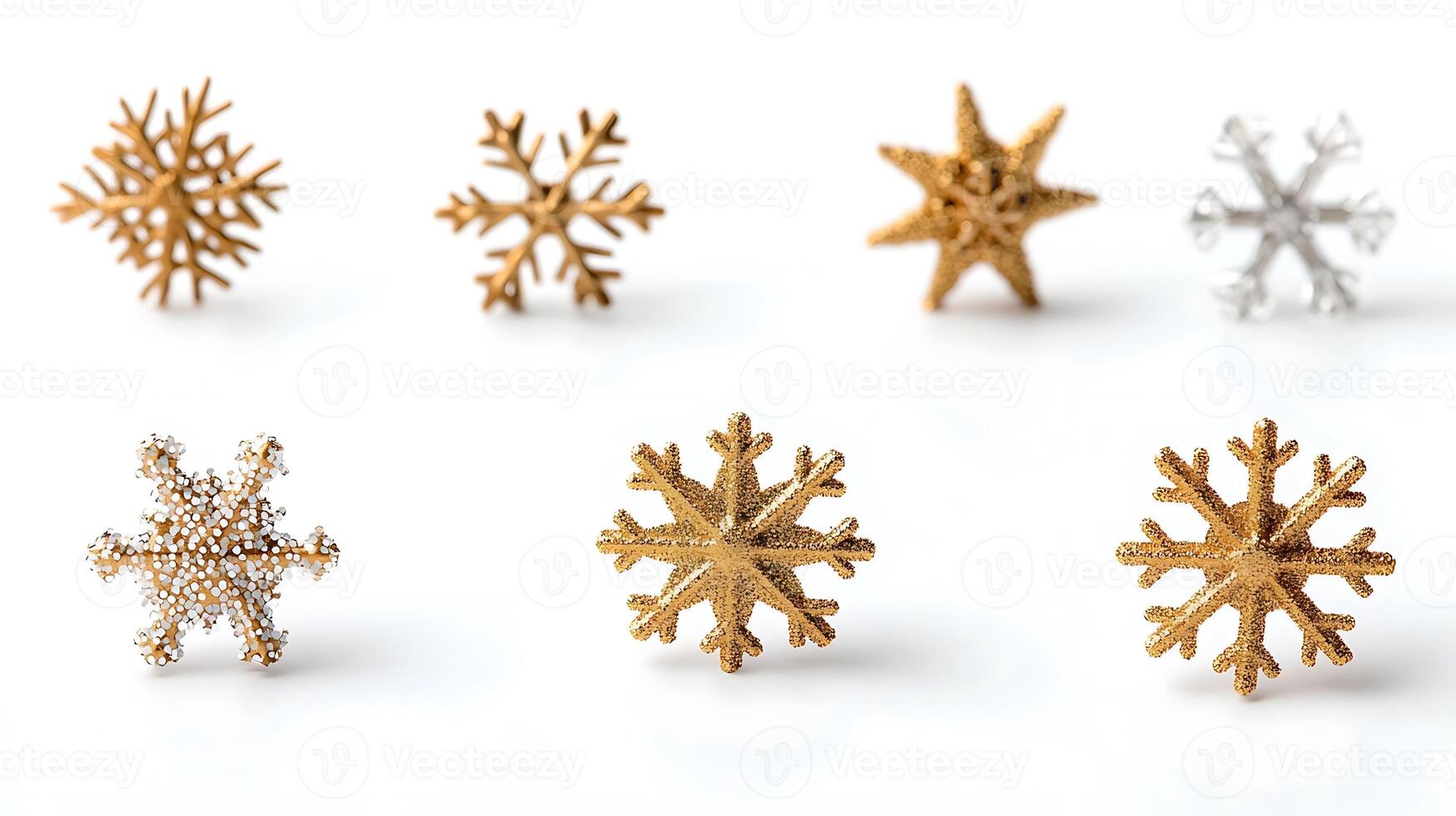 Collection of decorative snowflake ornaments in various metallic finishes on a white background photo