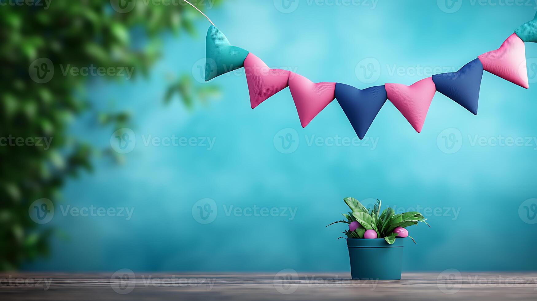 Colorful decorative bunting above a potted plant on a wooden table with a soft blue background photo