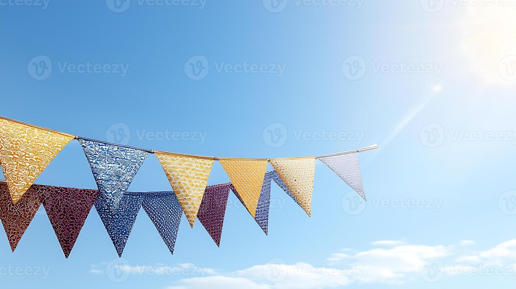 Colorful festive bunting flags fluttering in a clear blue sky with sunlight and clouds photo