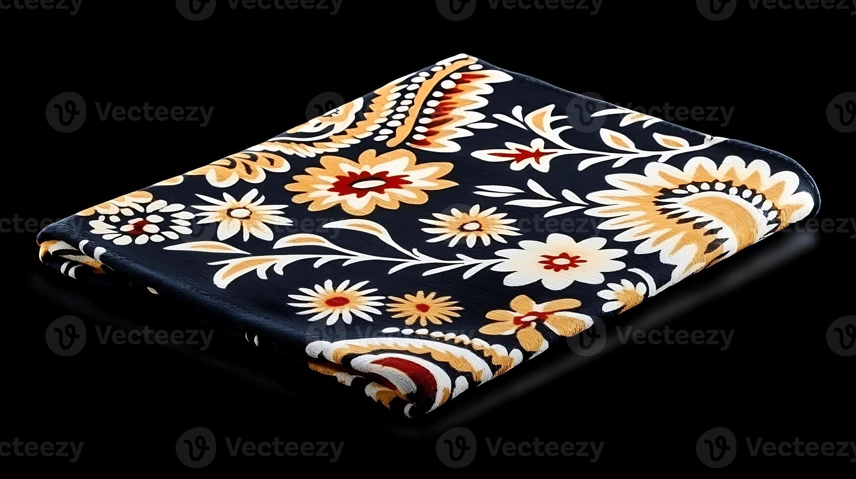 A black and white floral patterned towel on a black background photo