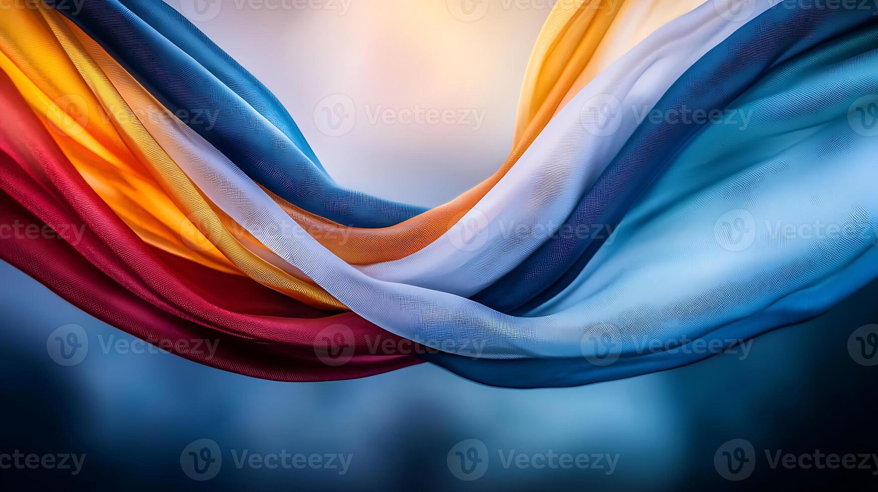Colorful flowing fabric in vibrant hues of red, yellow, blue, and white against a soft background photo