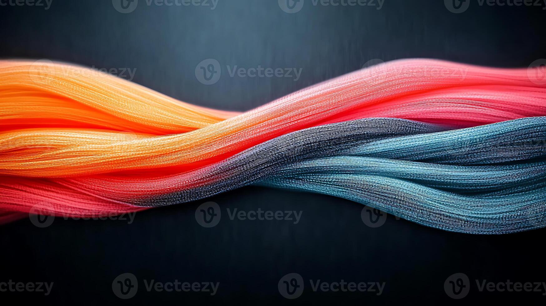 Colorful flowing strands of fabric intertwining against a dark backdrop, creating a dynamic visual effect photo