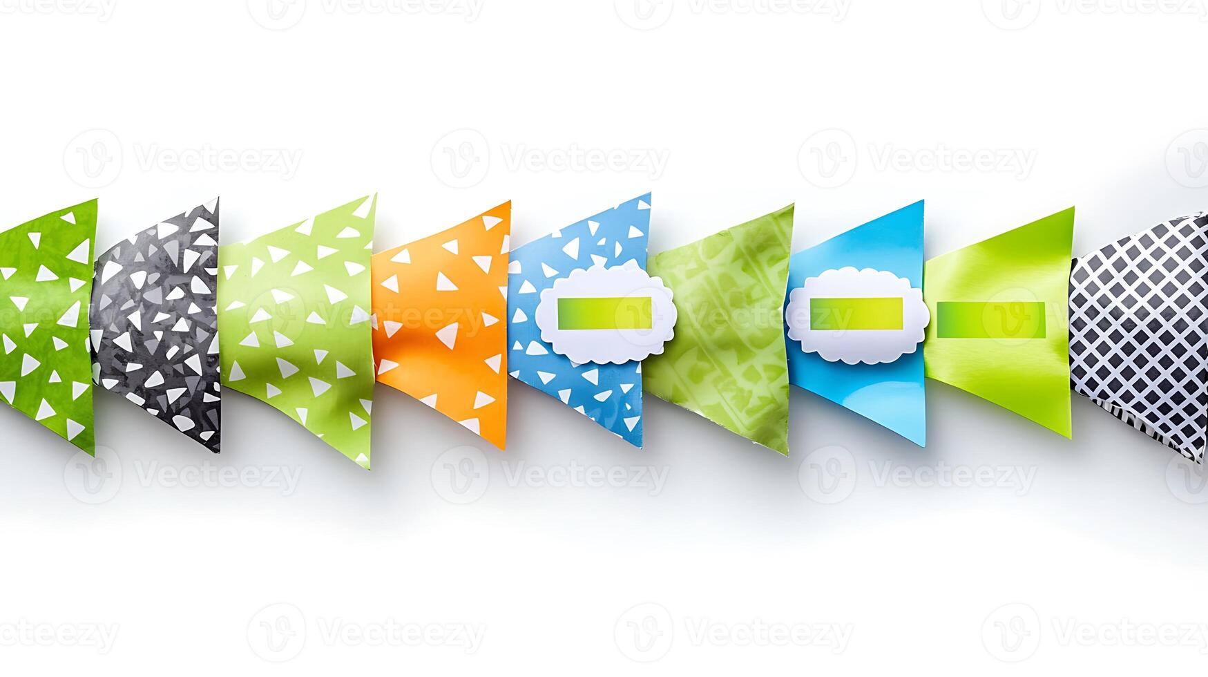 Colorful geometric paper shapes arranged in a line, showcasing vibrant patterns and textures photo
