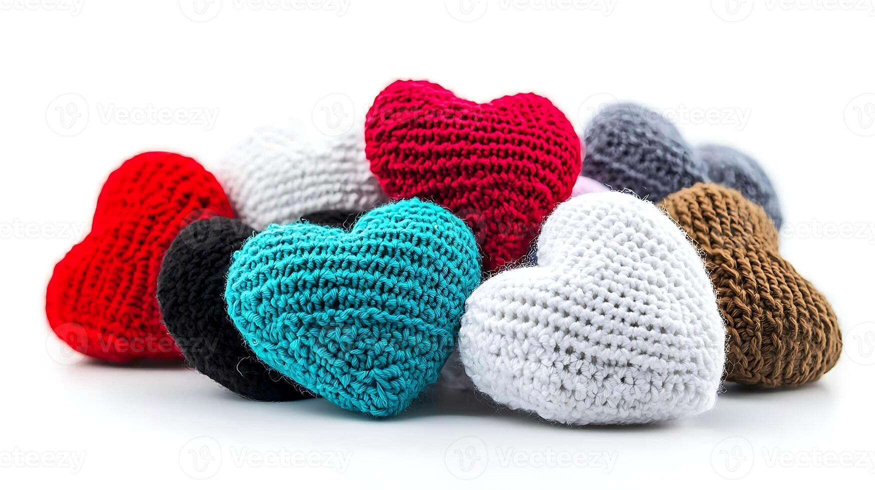 Colorful knitted hearts arranged in a pile, showcasing various shades and textures on a white background photo