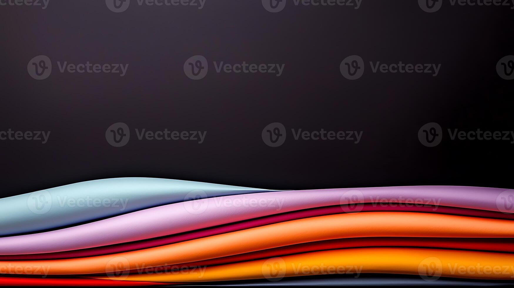 Colorful layered fabric textures with smooth curves against a dark background for design use photo