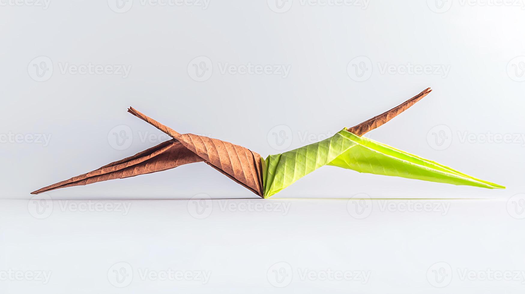 Colorful origami bird made from paper leaves displayed against a minimalist background photo
