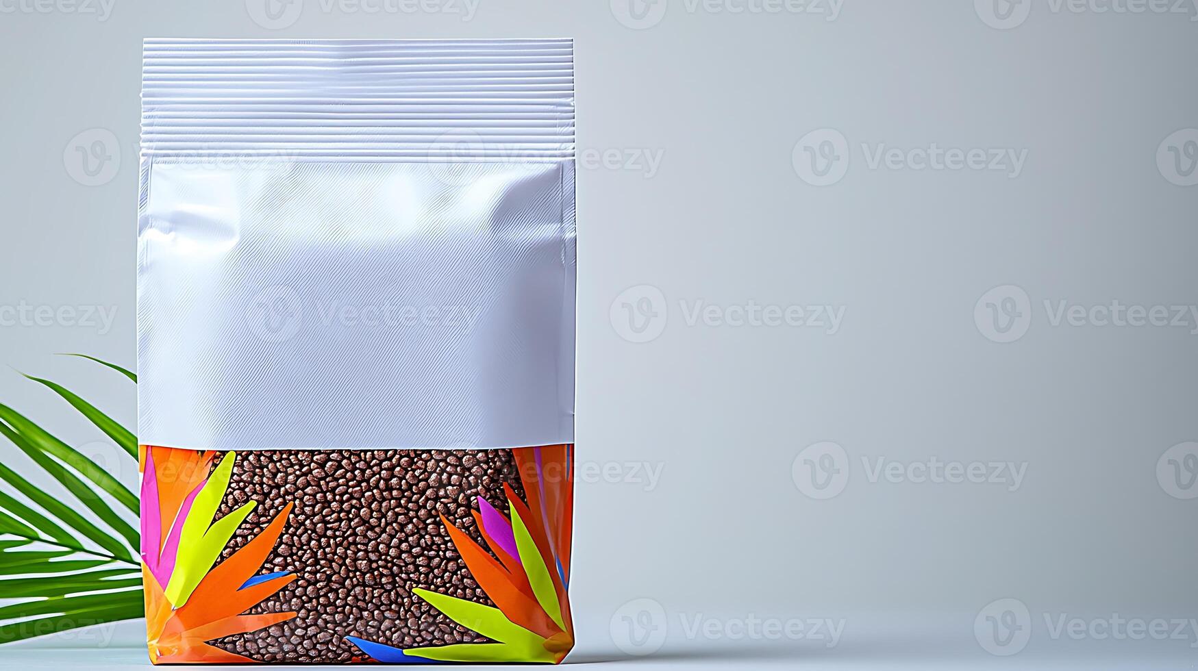 Colorful packaging of seeds displayed on a clean surface with a tropical leaf in the foreground photo