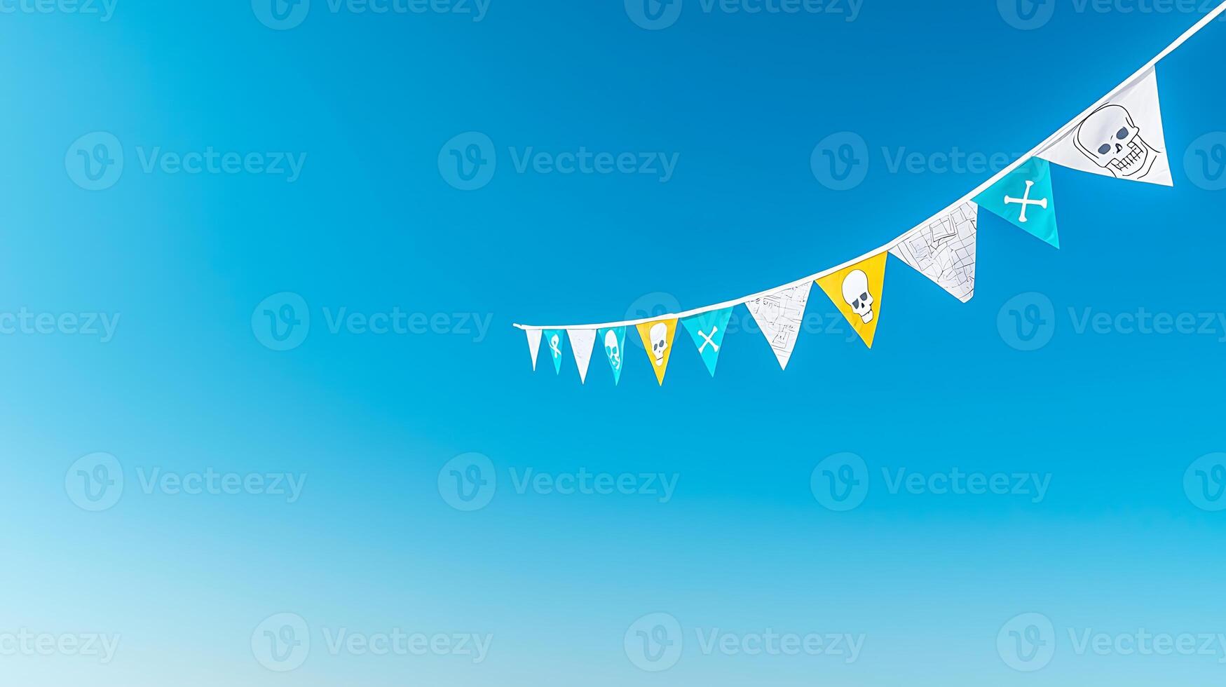 Colorful pirate-themed bunting flags hanging against a bright blue sky, creating a festive atmosphere photo