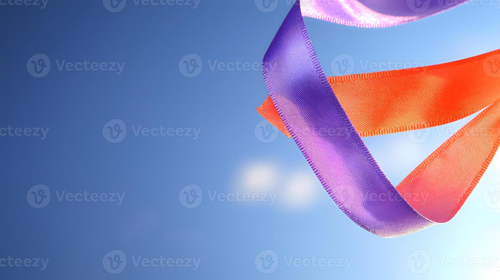Colorful ribbons gracefully swirling against a clear blue sky, creating a vibrant visual display photo