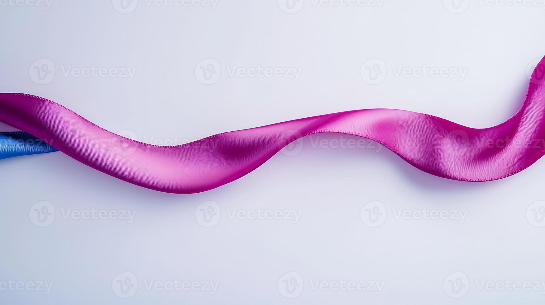 Colorful satin ribbons in pink and blue gracefully flowing across a smooth white surface photo