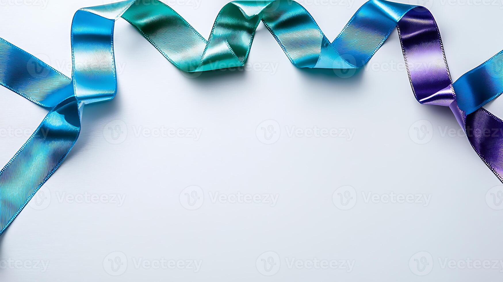 Colorful satin ribbons in blue, green, and purple arranged artistically on a white background photo