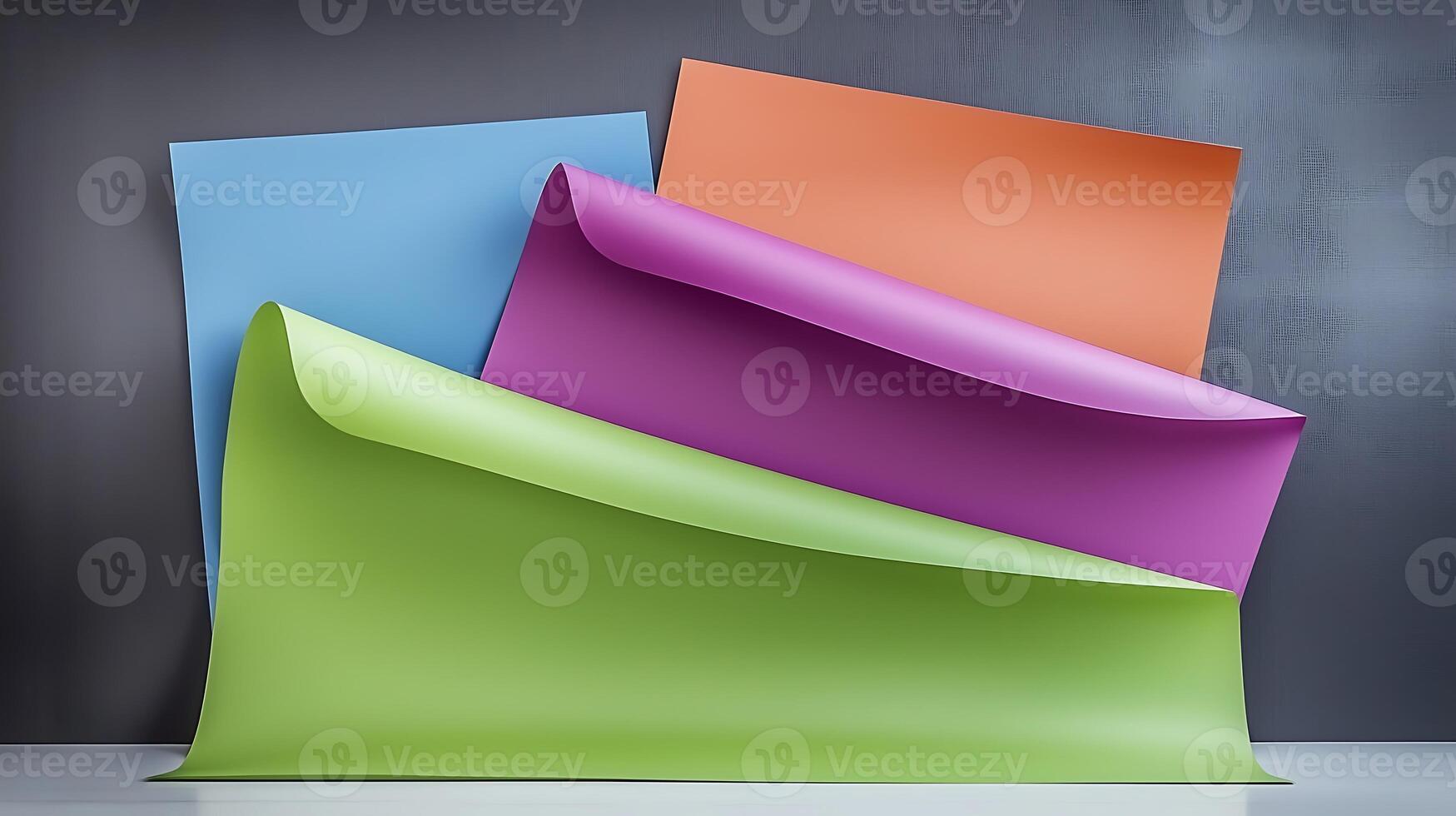 Colorful sheets of paper cascading over each other against a textured gray background photo