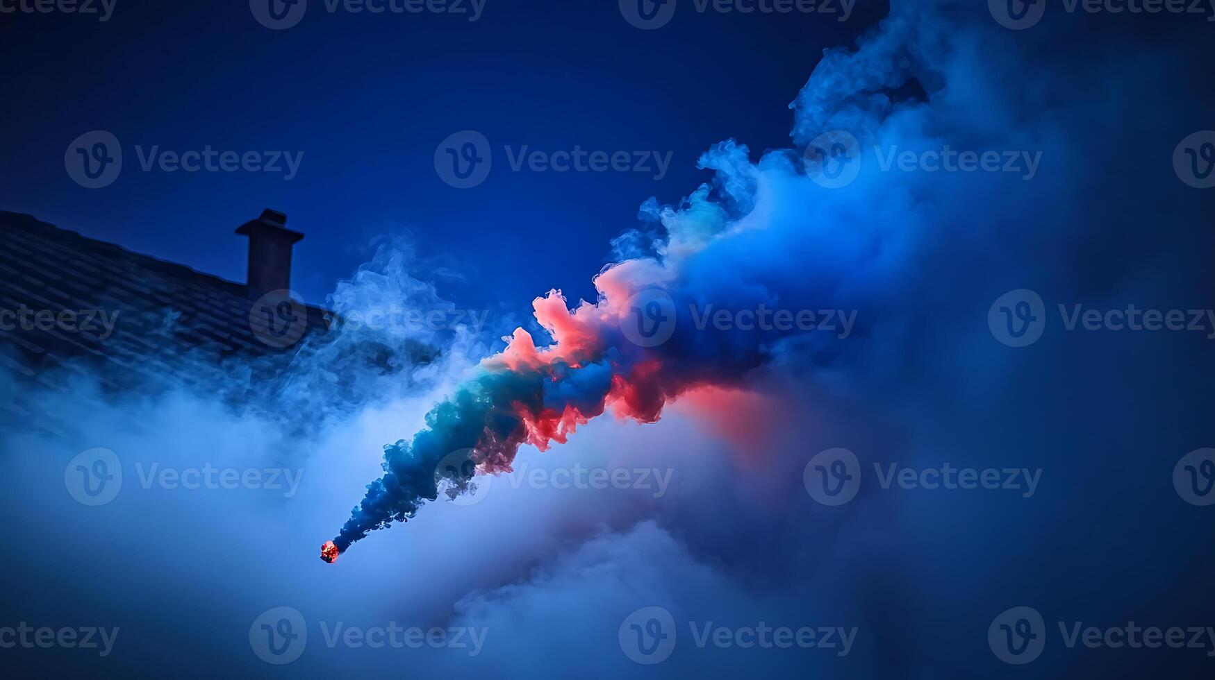 Colorful smoke emerging from a rooftop at dusk, creating a dramatic atmosphere in the background photo