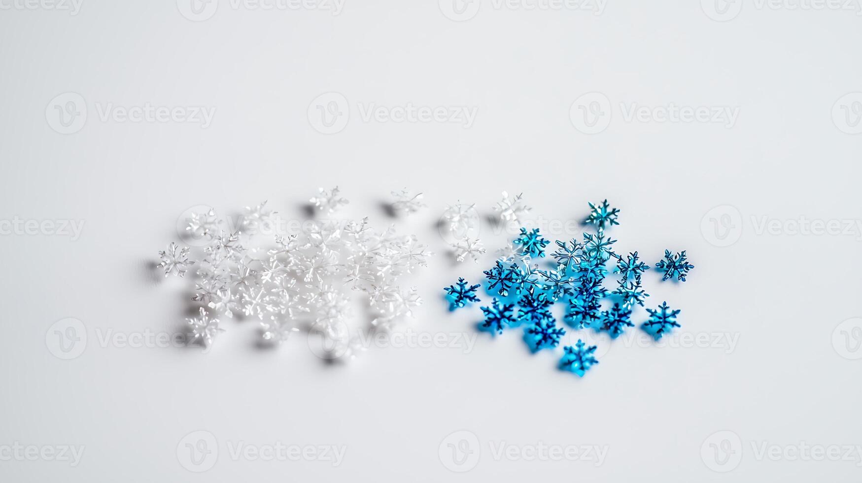 Colorful snowflake decorations in white and blue arranged on a clean surface for festive use photo