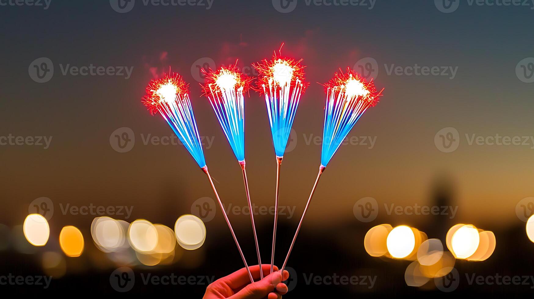 Colorful sparklers held against a twilight sky, illuminating a festive atmosphere with bokeh lights photo
