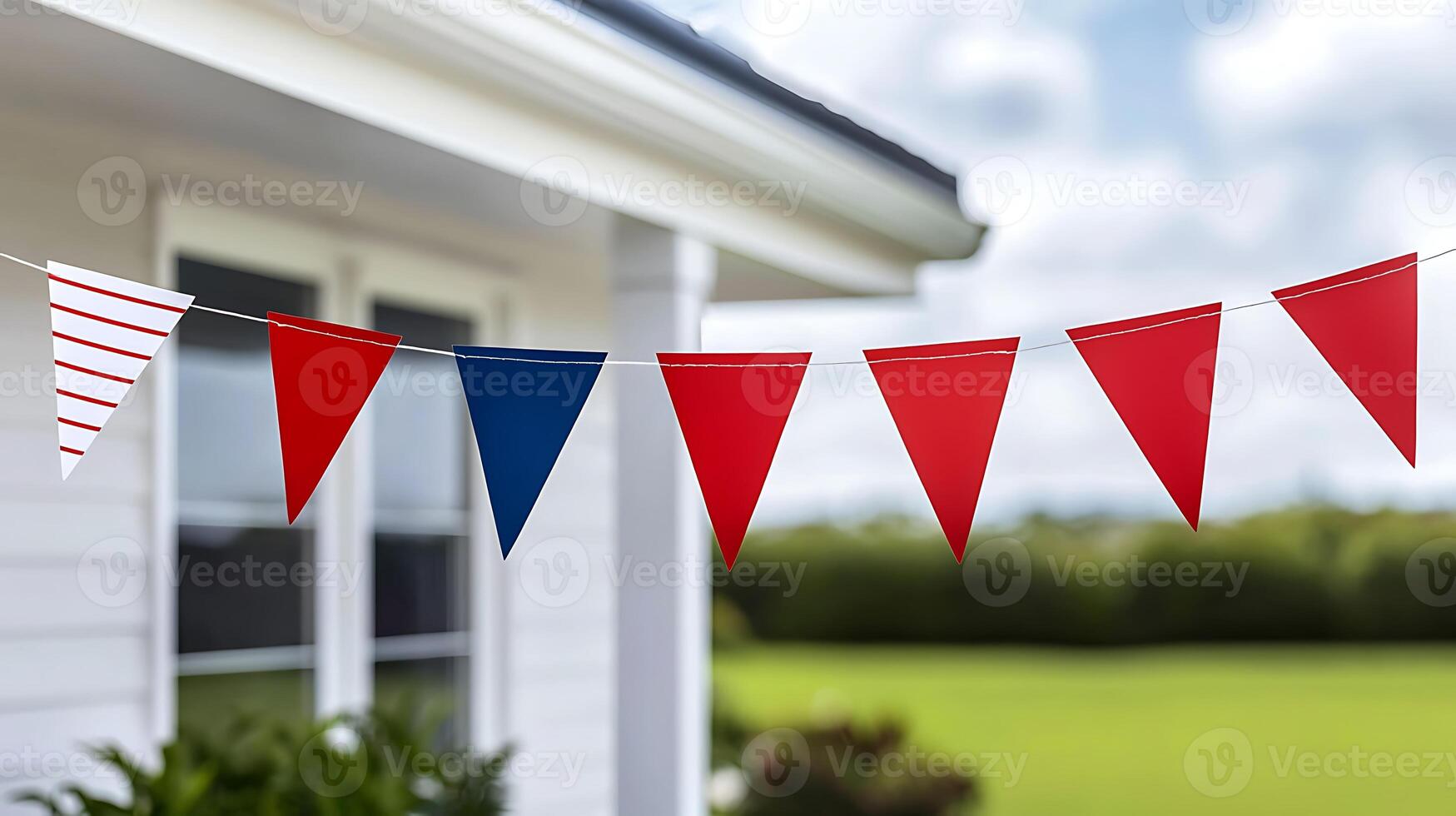 A red, white and blue bunting is hanging from a line photo
