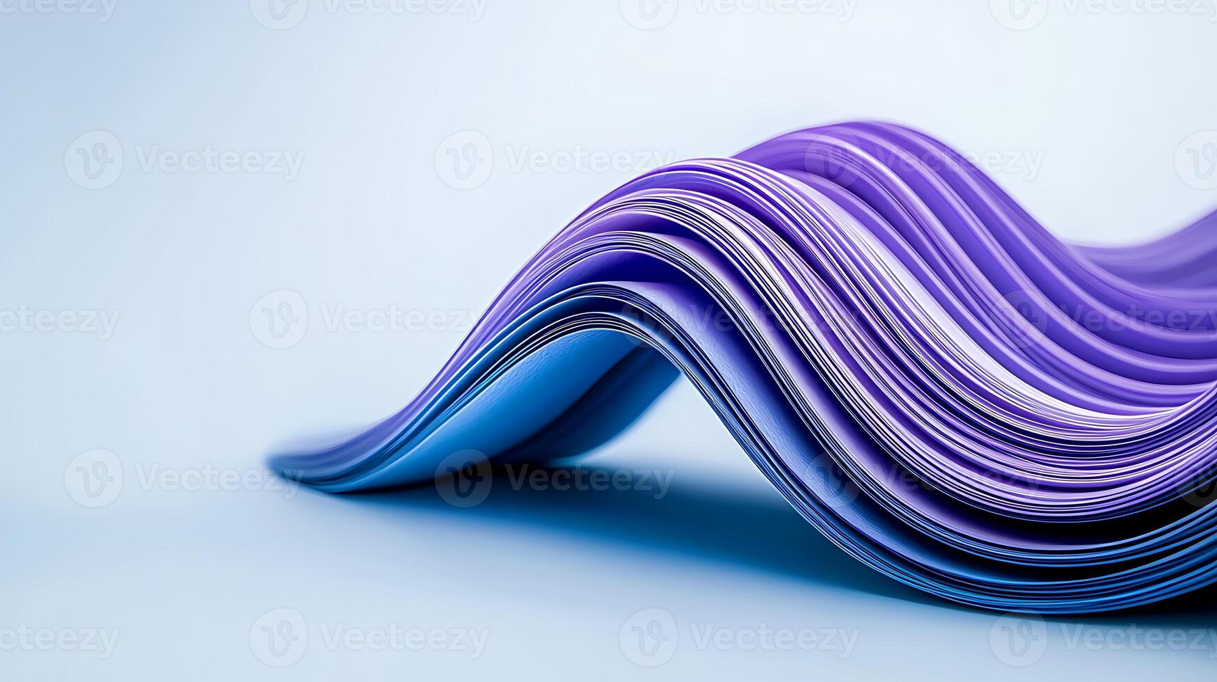 Colorful wave of paper sheets in shades of blue and purple, creating an artistic background effect photo