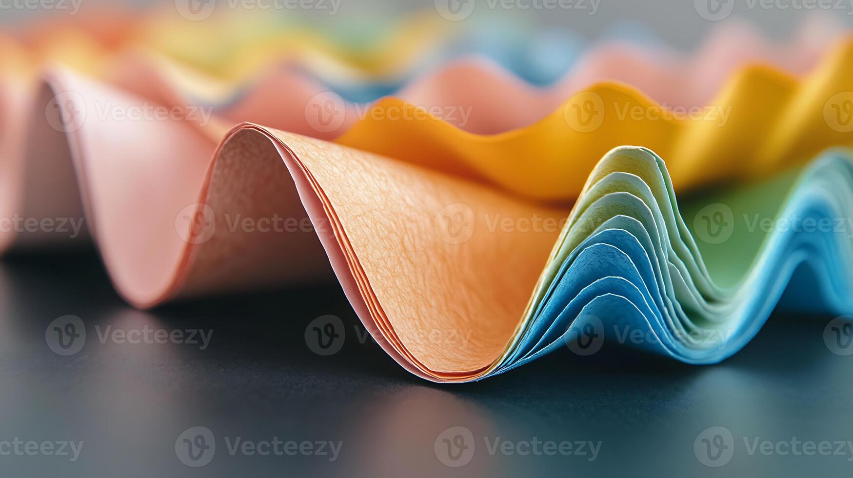 Colorful, wavy paper sheets arranged artistically on a dark surface, showcasing texture and hues photo