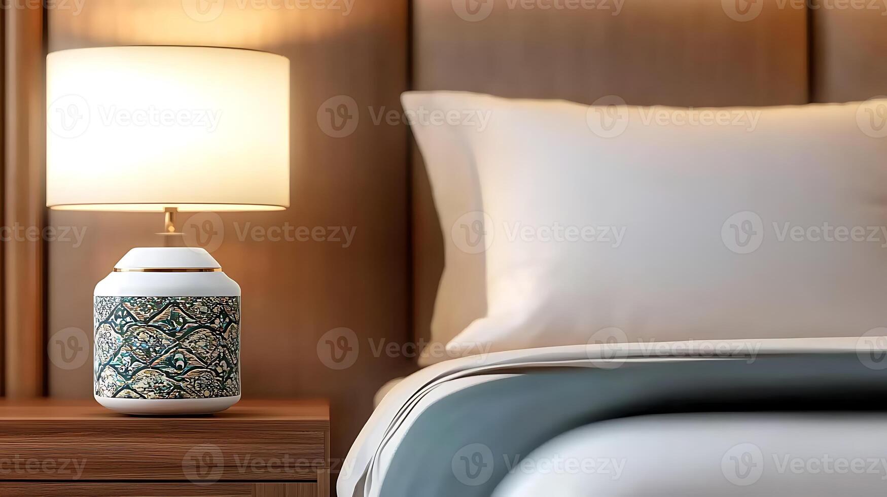 Cozy bedroom scene featuring a decorative lamp on a nightstand beside a neatly made bed photo