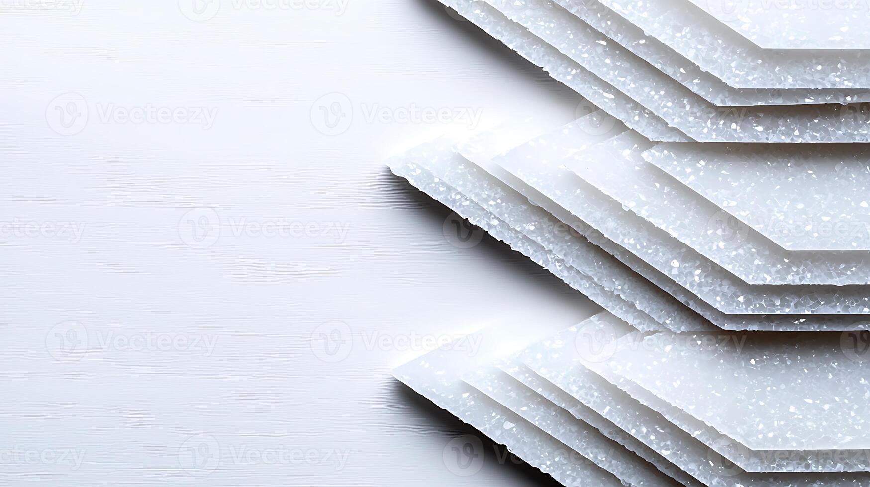 Stacked white geometric shapes on a light wooden surface, creating a minimalist aesthetic photo