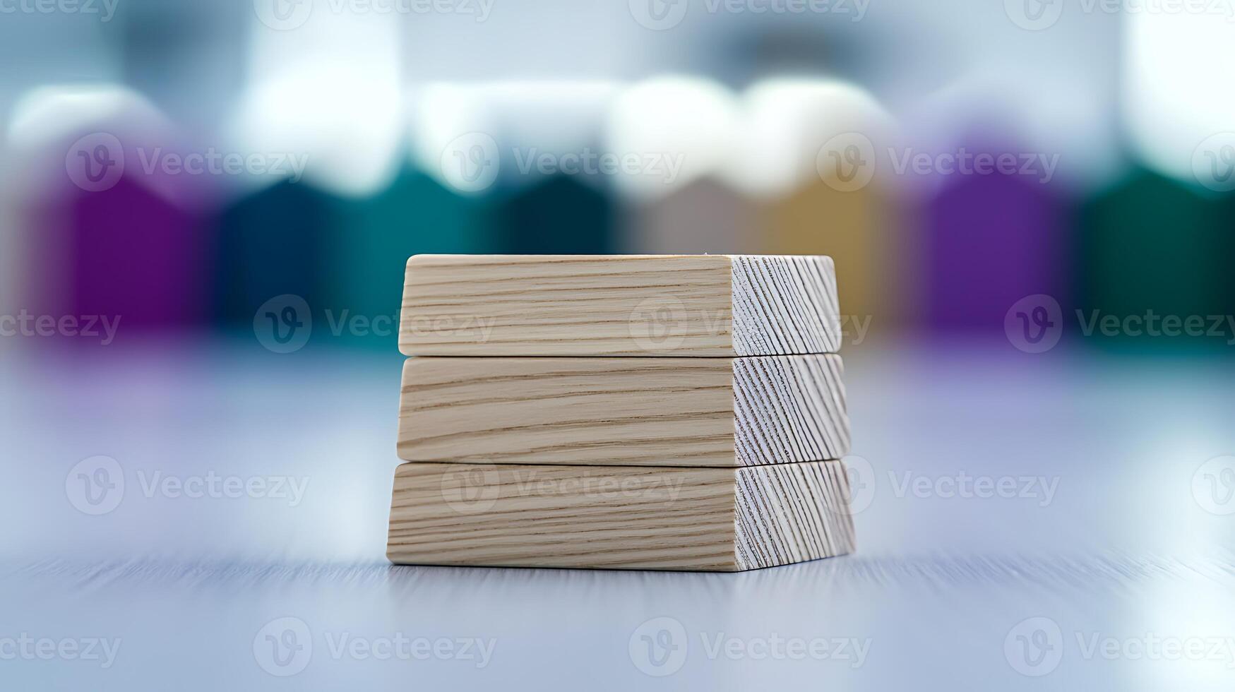 Stacked wooden blocks on a blurred background of colorful house shapes, ideal for educational use photo