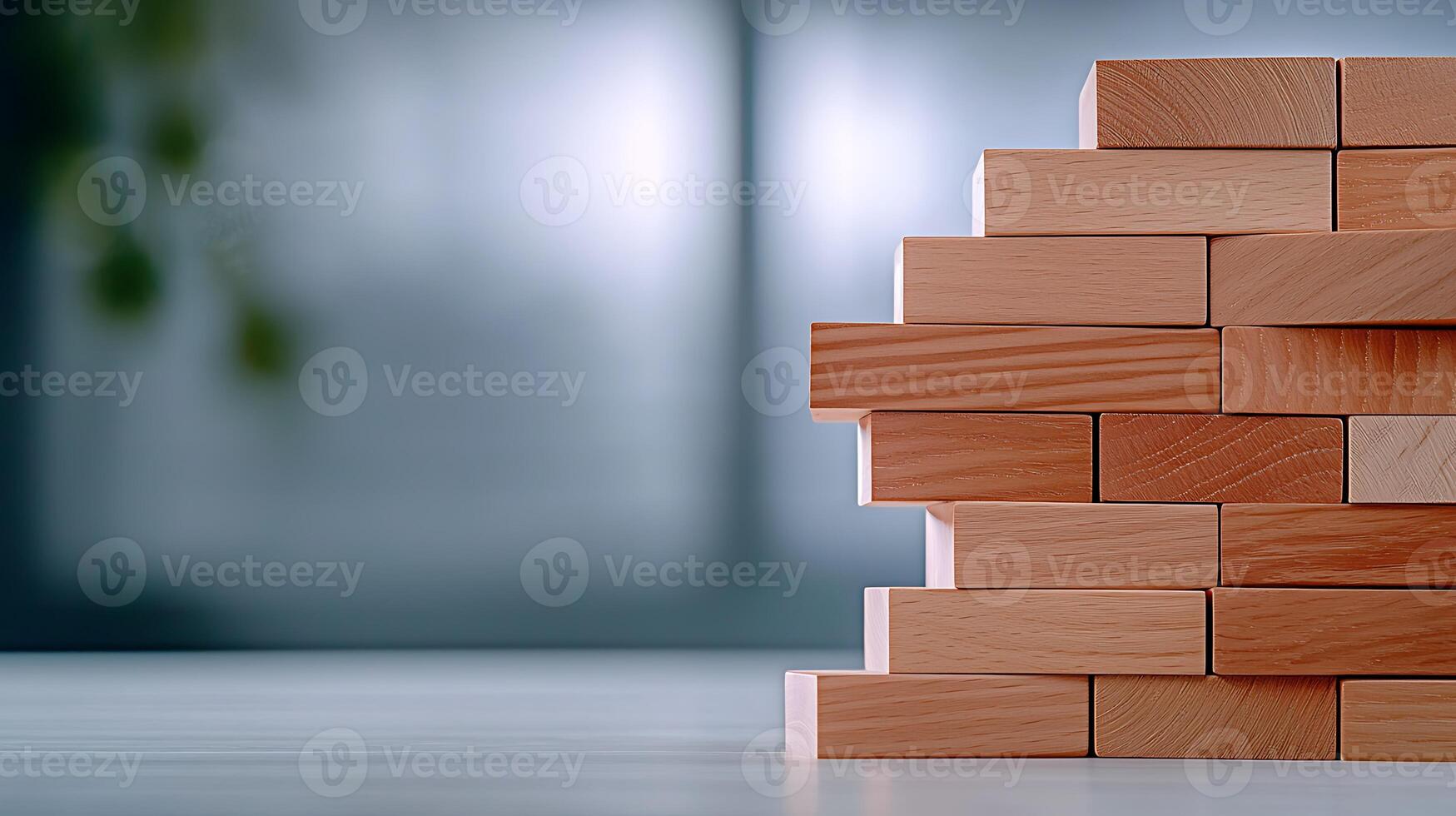 Stacked wooden blocks on a table with a blurred background suggesting a calm workspace photo