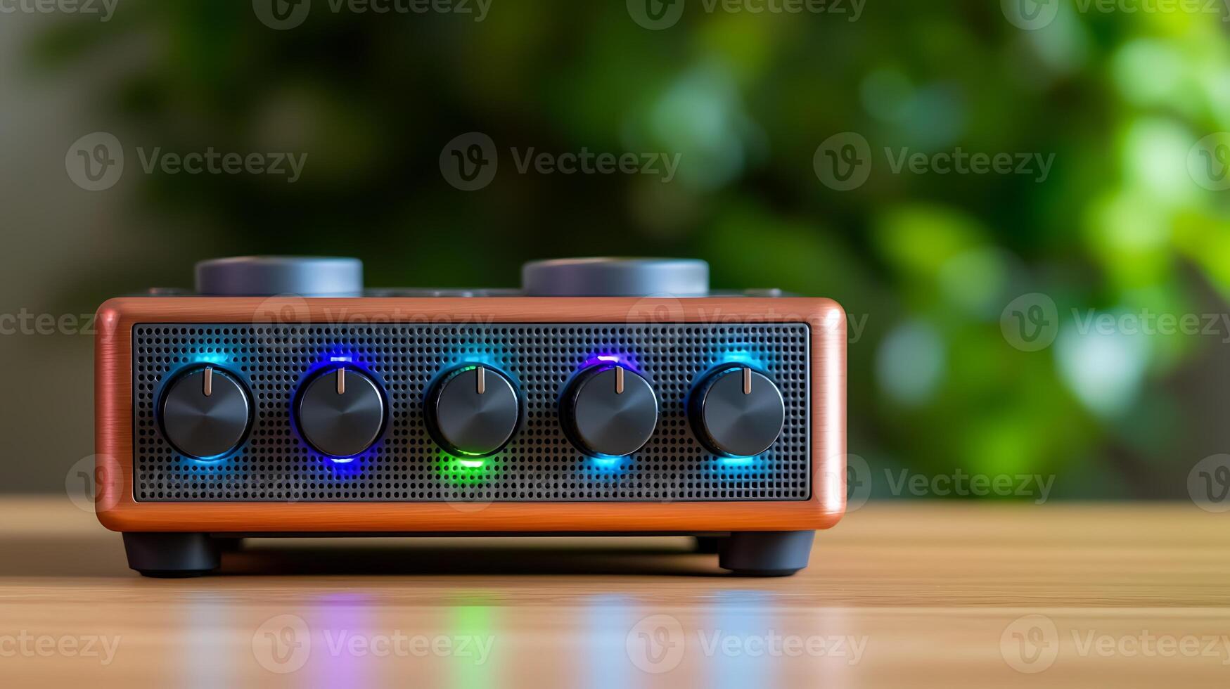 Stylish audio mixer with colorful LED lights on a wooden table, surrounded by greenery photo