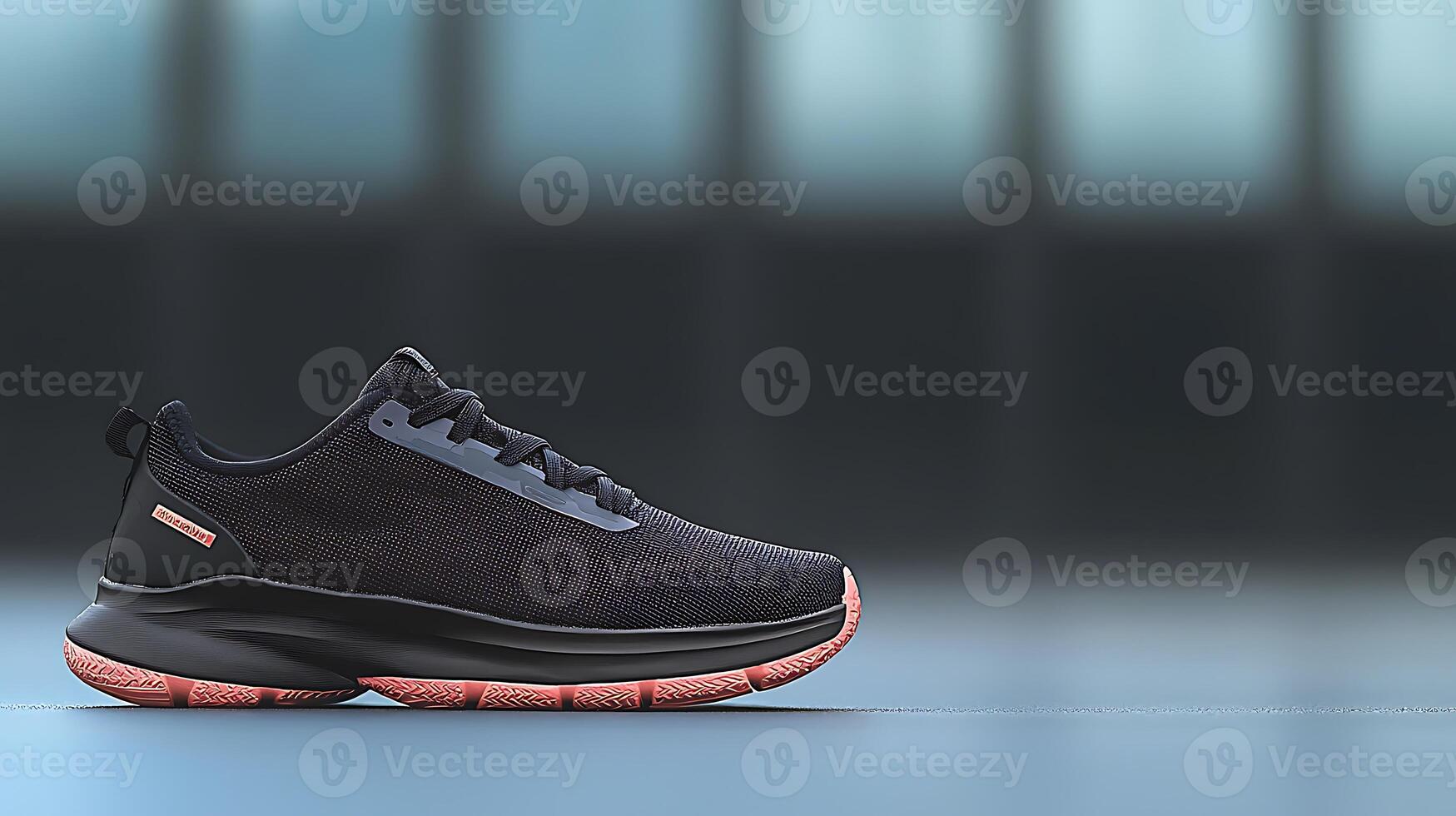 Stylish black athletic shoe positioned on a smooth surface with a blurred background photo